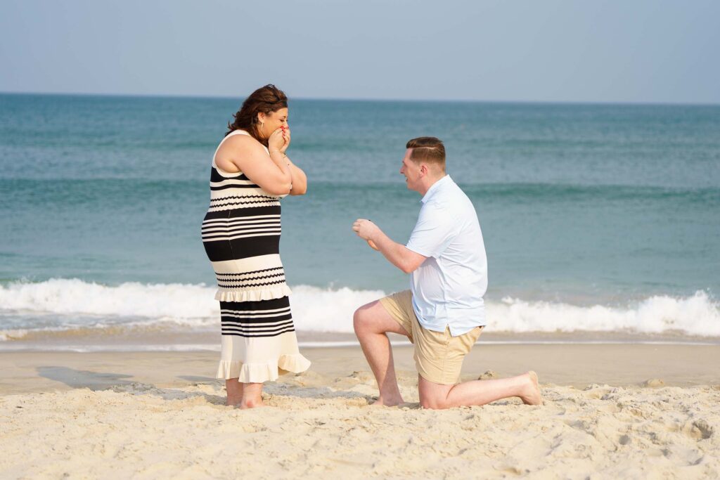 Wedding proposal on beach man on one knee