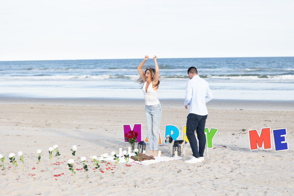 Excited future bide jumping up after proposal on the beach