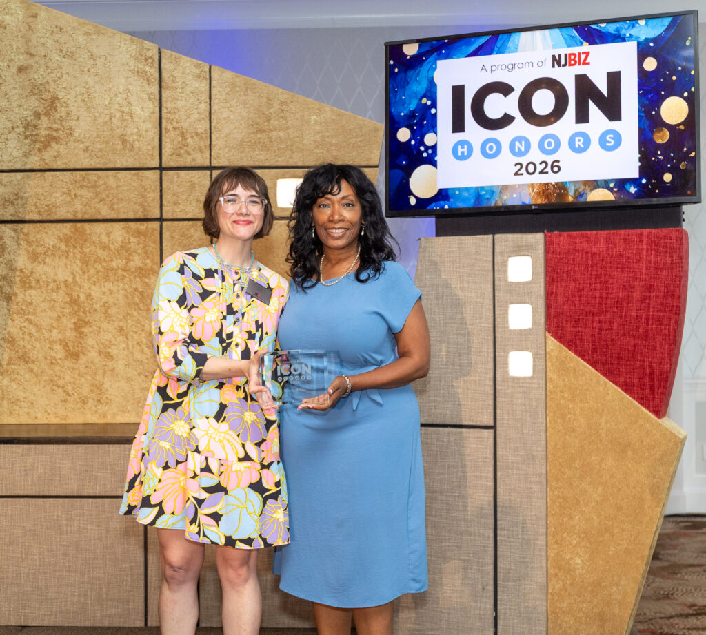 woman receiving an award on stage for NJBIZ