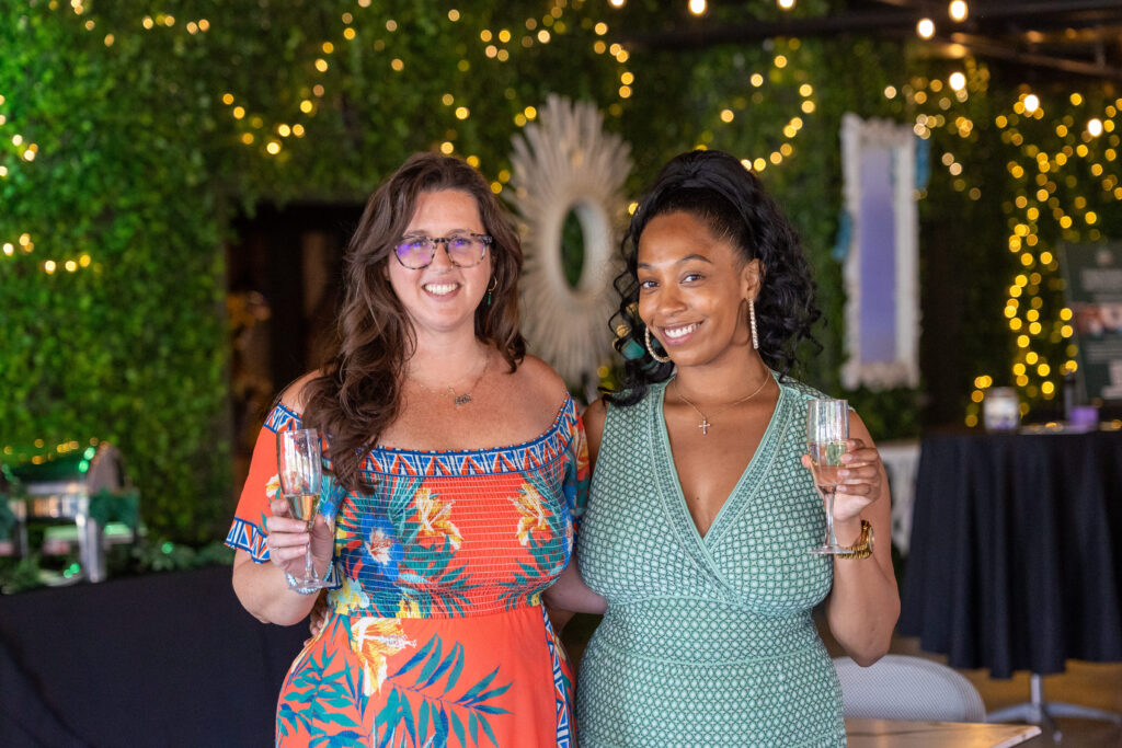 two women with Champagne glasses at event
