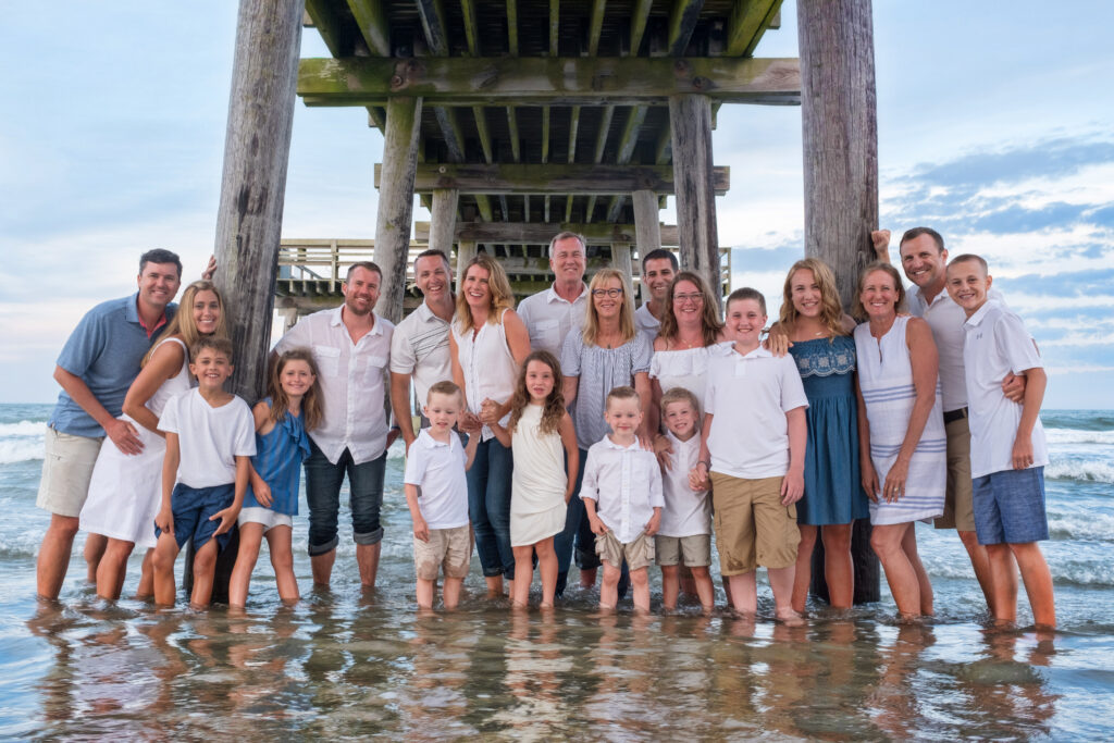 Large extended family group photo on beach under pier Avalon NJ 