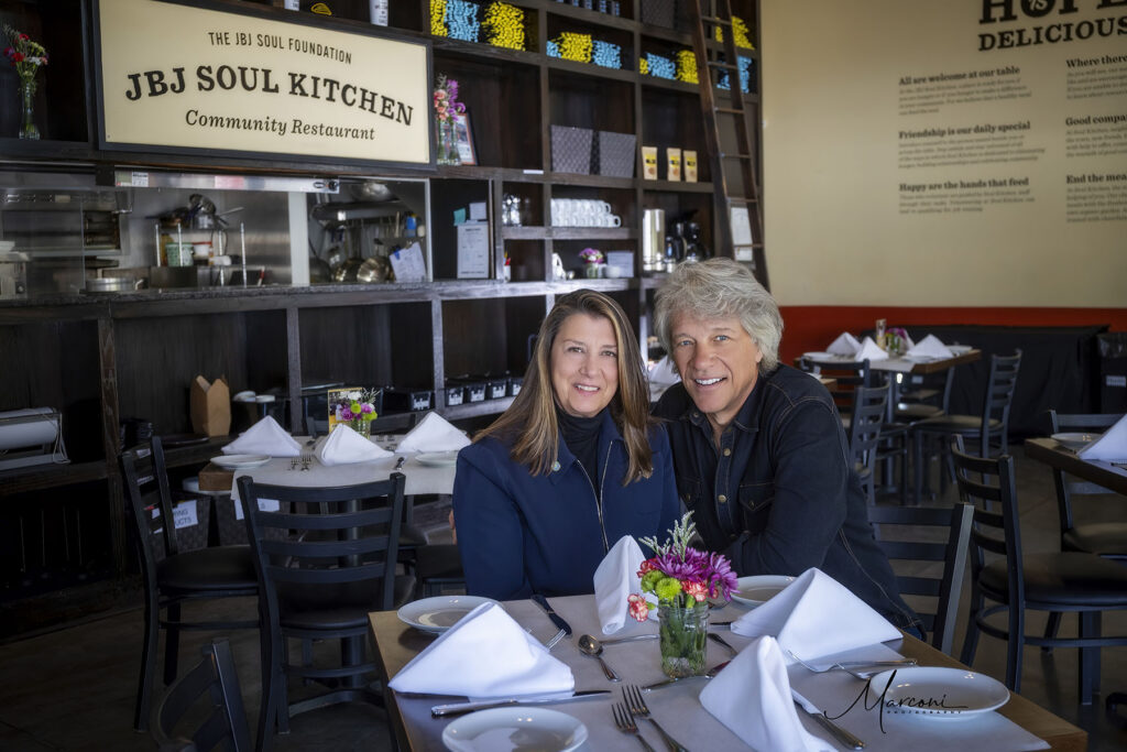 Jon BonJovi and Dorthea siting at table in JBJ Soul kitchen